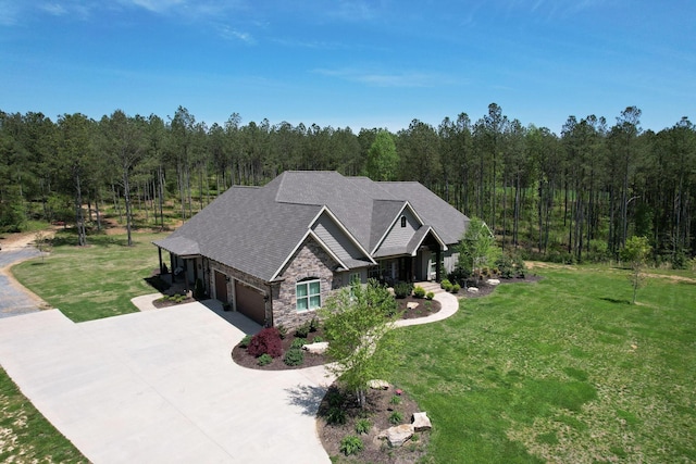 drone / aerial view featuring a wooded view