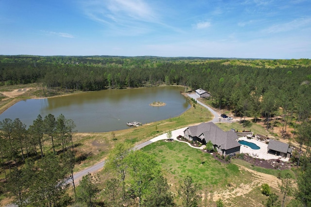 drone / aerial view featuring a water view and a view of trees