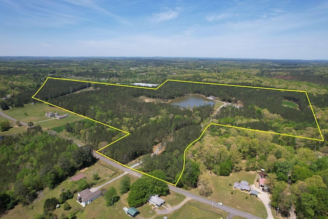 aerial view with a water view and a wooded view