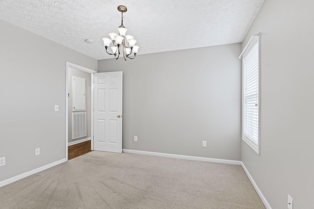 800 S Browns Ln Unit I1, Gallatin, TN 37066 - empty room with an inviting chandelier, a textured ceiling, and a wealth of natural light