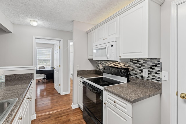 800 S Browns Ln Unit I1, Gallatin, TN 37066 - kitchen featuring dark countertops, dark wood finished floors, black electric range oven, white microwave, and backsplash