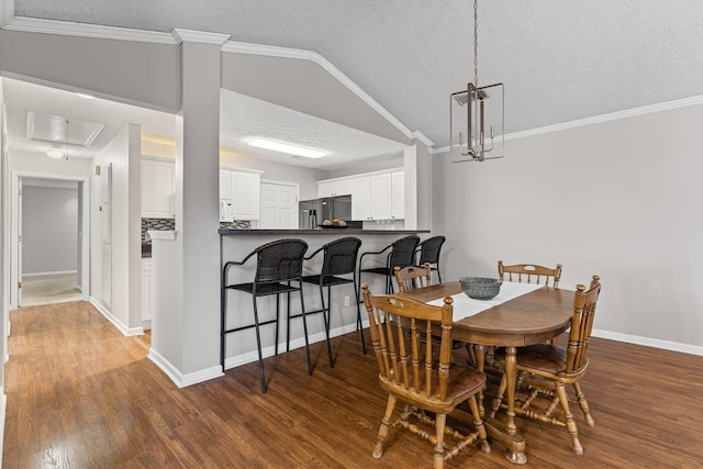 800 S Browns Ln Unit I1, Gallatin, TN 37066 - dining space featuring crown molding, baseboards, a textured ceiling, and wood finished floors