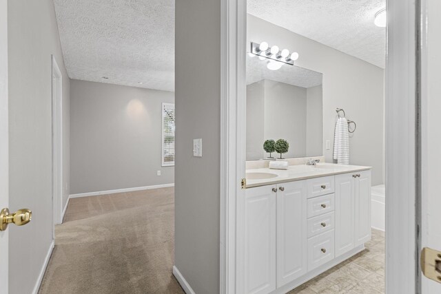 800 S Browns Ln Unit I1, Gallatin, TN 37066 - bathroom with a sink, double vanity, a textured ceiling, and a tub to relax in