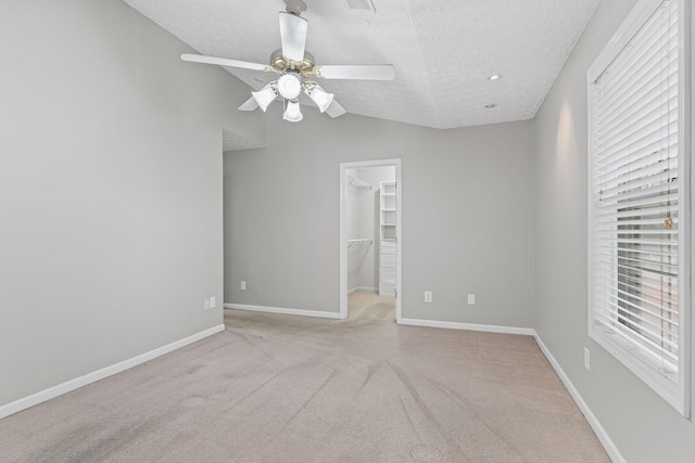 800 S Browns Ln Unit I1, Gallatin, TN 37066 - empty room with light carpet, a textured ceiling, a ceiling fan, baseboards, and vaulted ceiling
