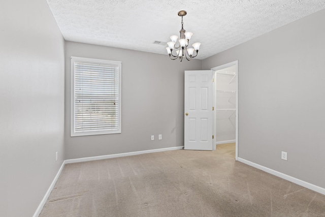 800 S Browns Ln Unit I1, Gallatin, TN 37066 - carpeted empty room featuring baseboards, a textured ceiling, a notable chandelier, and visible vents