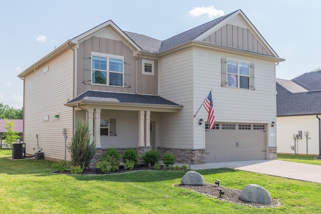 craftsman-style home featuring a garage, board and batten siding, central AC, and a front yard