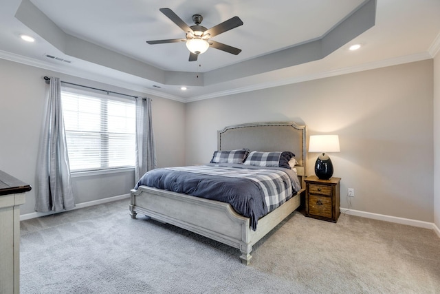 bedroom featuring visible vents, ornamental molding, a raised ceiling, and baseboards