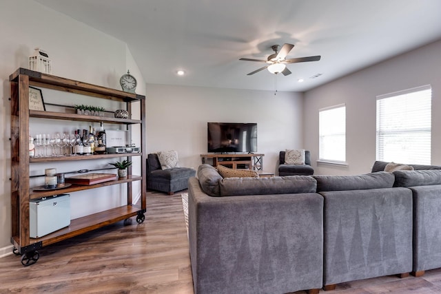 living area featuring recessed lighting, ceiling fan, visible vents, and wood finished floors