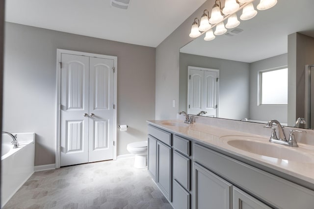 full bath featuring baseboards, a sink, a garden tub, and double vanity
