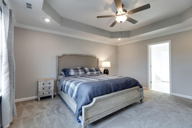 carpeted bedroom featuring recessed lighting, a tray ceiling, visible vents, and ornamental molding