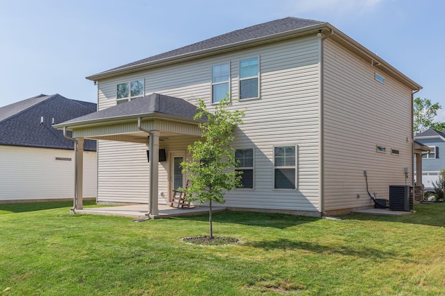 view of front of house with a front lawn, a patio area, and cooling unit