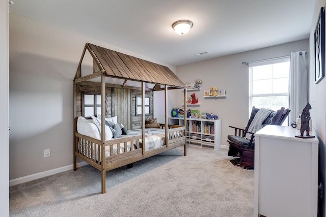carpeted bedroom with baseboards and visible vents