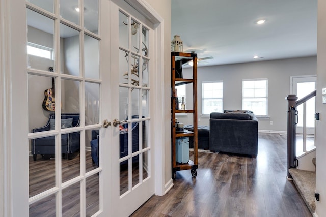 hallway featuring french doors, stairs, dark wood-type flooring, and baseboards