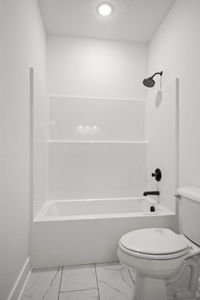 full bathroom featuring baseboards, marble finish floor, toilet, and shower / washtub combination