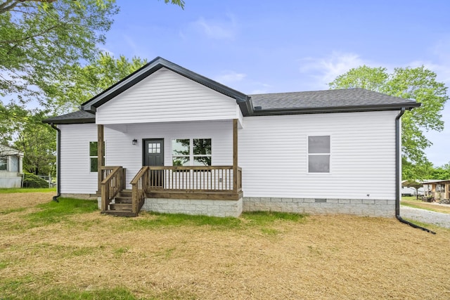 rear view of house with a lawn, a shingled roof, a porch, and crawl space