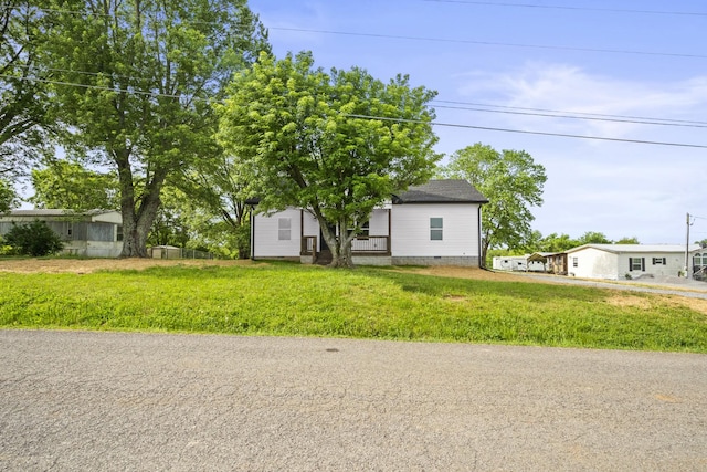 view of front of house featuring a shingled roof and crawl space