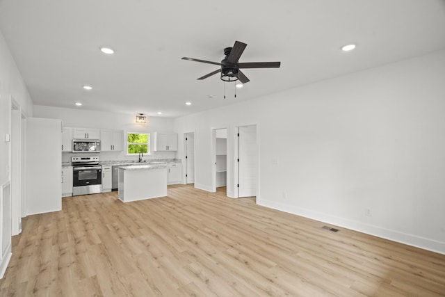unfurnished living room featuring recessed lighting, light wood-style floors, ceiling fan, and visible vents