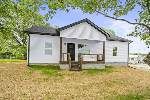 back of house with a yard, crawl space, a shingled roof, and covered porch