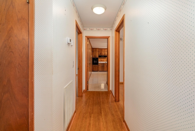 905 Crownhill Dr, Nashville, TN 37217 - hall featuring wallpapered walls, visible vents, ornamental molding, and light wood-style flooring
