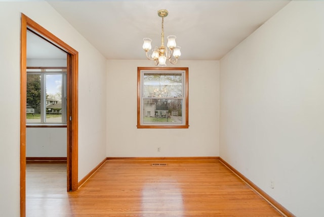 905 Crownhill Dr, Nashville, TN 37217 - unfurnished room with baseboards, visible vents, light wood-type flooring, and a notable chandelier