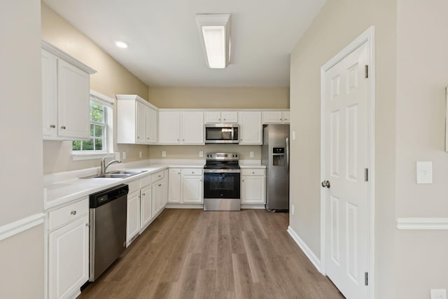 2300 Devonshire Dr, Old Hickory, TN 37138 - kitchen featuring appliances with stainless steel finishes, a sink, light wood-style flooring, and white cabinetry