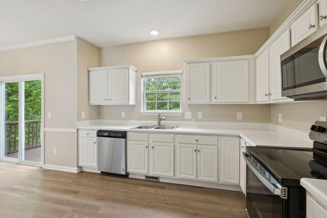 2300 Devonshire Dr, Old Hickory, TN 37138 - kitchen featuring appliances with stainless steel finishes, a sink, white cabinetry, light wood finished floors, and light countertops