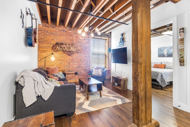 610 21st Ave N Unit 302, Nashville, TN 37203 - living area featuring brick wall, beam ceiling, and hardwood / wood-style flooring