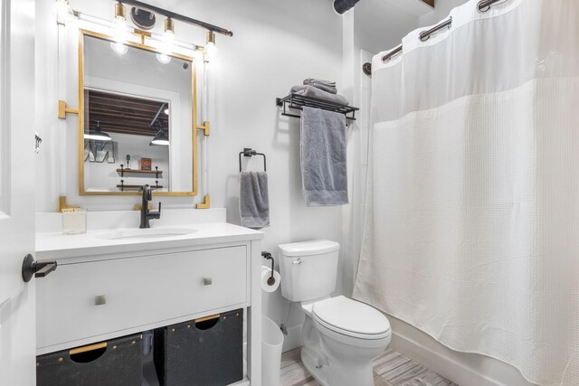 610 21st Ave N Unit 302, Nashville, TN 37203 - full bathroom with vanity, toilet, wood finished floors, and shower / tub combo with curtain
