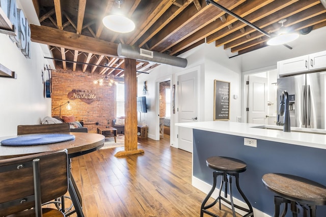 610 21st Ave N Unit 302, Nashville, TN 37203 - bathroom with baseboards, brick wall, visible vents, and wood finished floors