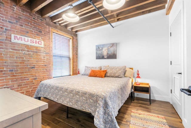 610 21st Ave N Unit 302, Nashville, TN 37203 - bedroom featuring beamed ceiling, brick wall, baseboards, and wood finished floors