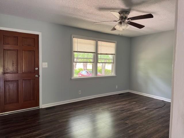 4660 Dover Rd, Indian Mound, TN 37079 - unfurnished room with baseboards, a ceiling fan, a textured ceiling, and dark wood-style floors