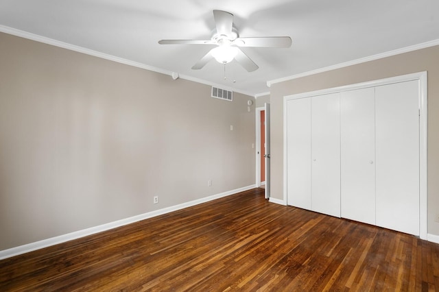 unfurnished bedroom with visible vents, ornamental molding, a closet, baseboards, and dark wood finished floors