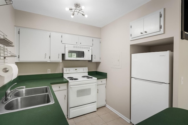 kitchen with light tile patterned flooring, white appliances, baseboards, white cabinetry, and a sink