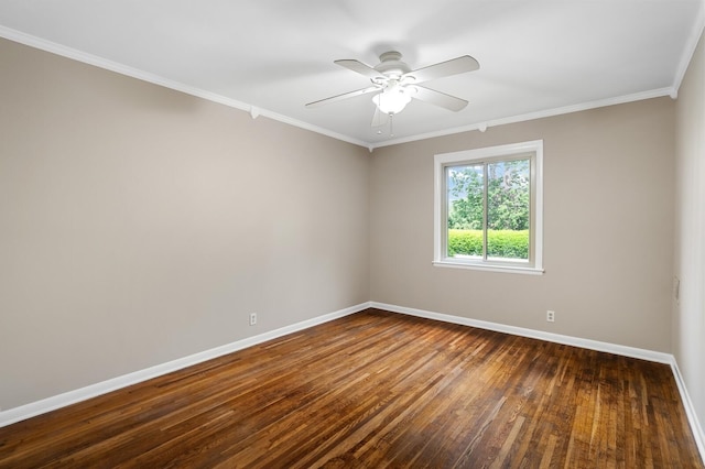 spare room featuring crown molding, baseboards, a ceiling fan, and dark wood-type flooring