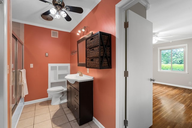 bathroom featuring ceiling fan, visible vents, a shower stall, and baseboards