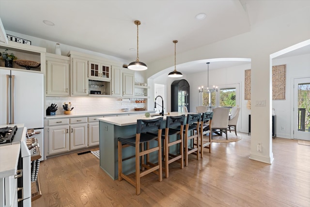 5960 Lickton Pike, Goodlettsville, TN 37072 - kitchen featuring open shelves, decorative backsplash, light countertops, arched walkways, and high end range