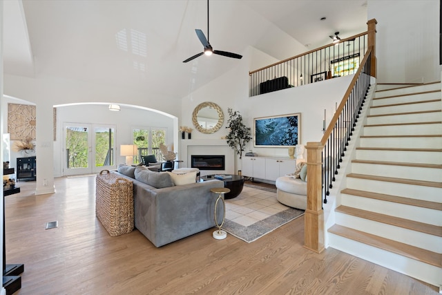 5960 Lickton Pike, Goodlettsville, TN 37072 - living area with a glass covered fireplace, wood finished floors, high vaulted ceiling, arched walkways, and a ceiling fan
