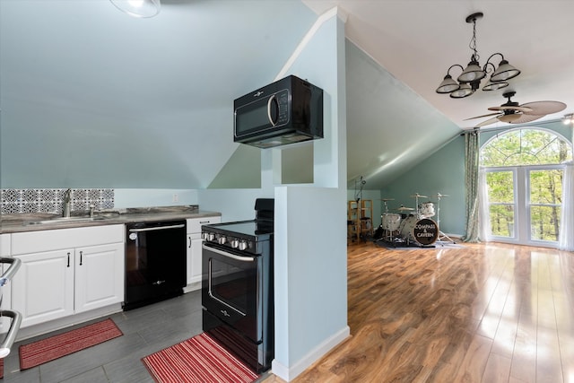 5960 Lickton Pike, Goodlettsville, TN 37072 - kitchen with a sink, black appliances, ceiling fan with notable chandelier, lofted ceiling, and white cabinetry