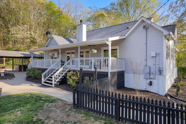 5960 Lickton Pike, Goodlettsville, TN 37072 - rear view of house featuring fence, a chimney, stairs, a shingled roof, and a porch