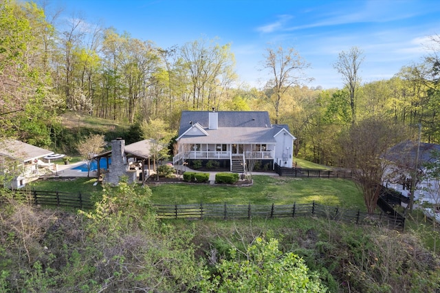 5960 Lickton Pike, Goodlettsville, TN 37072 - rear view of house with a wooded view, a fenced backyard, a yard, and a chimney