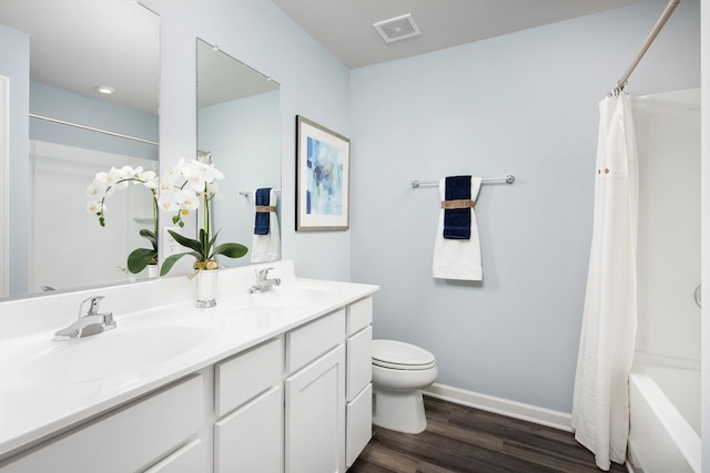 full bath with toilet, visible vents, a sink, and wood finished floors