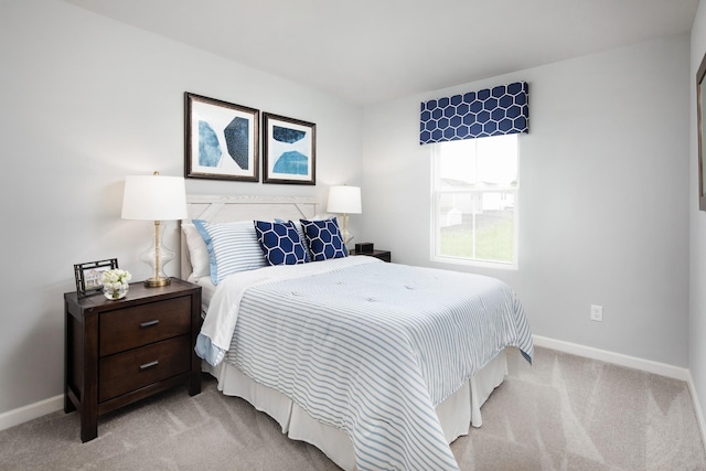 bedroom featuring carpet floors and baseboards