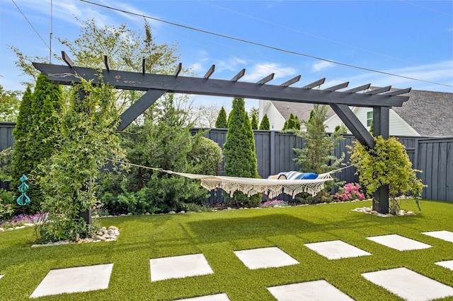 view of yard featuring fence and a pergola