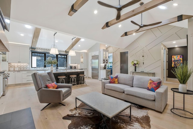 living room featuring vaulted ceiling with beams, recessed lighting, light wood finished floors, and ceiling fan