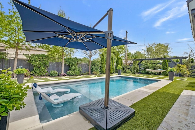 view of pool with fence, a fenced in pool, and a lawn