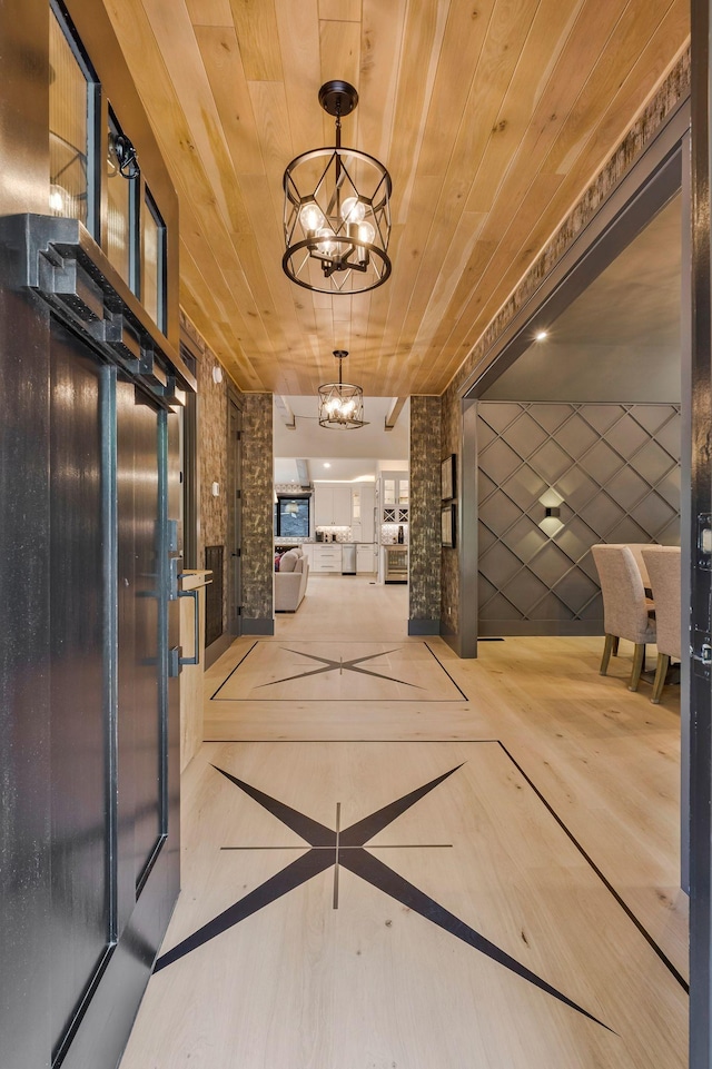 interior space featuring elevator, a chandelier, and wood ceiling