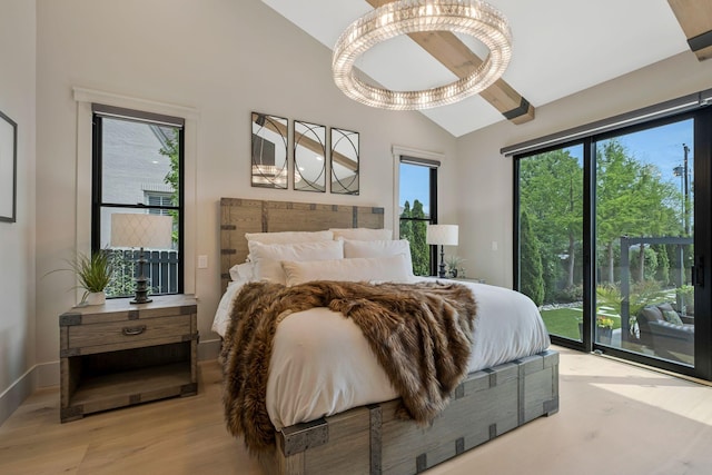 bedroom with light wood finished floors, lofted ceiling, and access to exterior