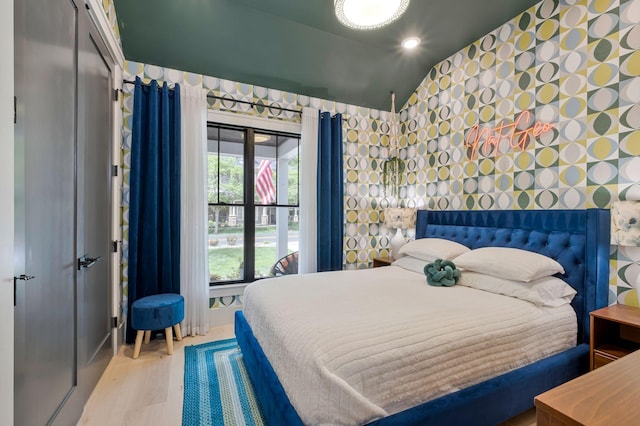 bedroom featuring recessed lighting, wallpapered walls, multiple windows, and wood finished floors