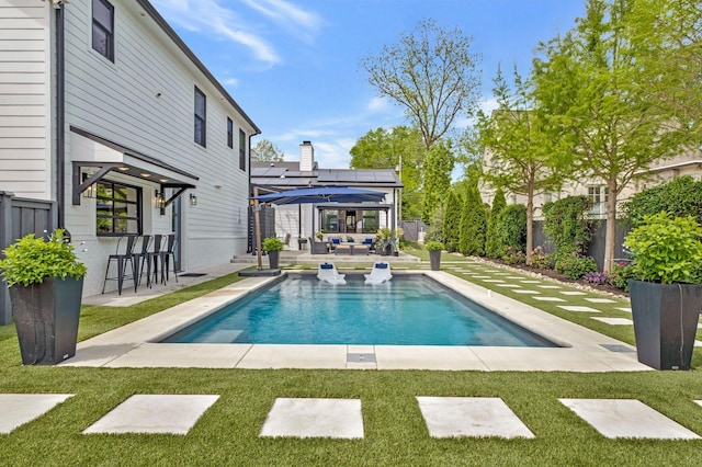 view of swimming pool with a lawn, a gazebo, outdoor lounge area, and outdoor dry bar