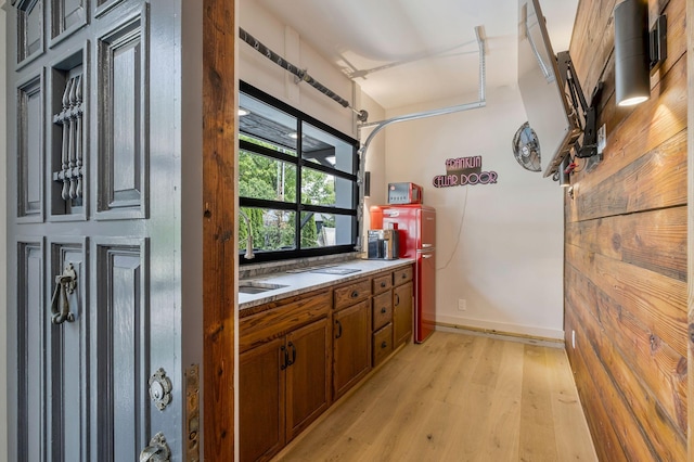 bar featuring baseboards and light wood-style floors